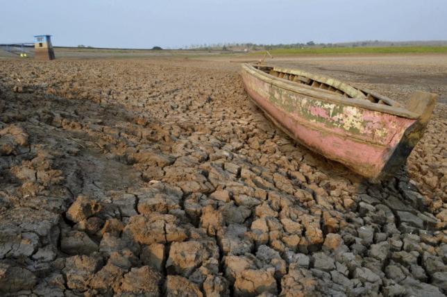 A wooden boat is seen stranded on the dry cracked riverbed of the Dawuhan Dam during drought season in Madiun, Indonesia's East Java province, Oct. 5, 2015.