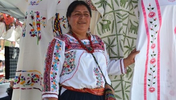 Constanza Garcia Lopez, an Indigenous woman from Oaxaca displays artisan clothing made by other indigenous survivors of domestic violence.