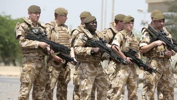 British soldiers pose for a photograph along the parade ground in Baghdad's fortified 