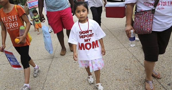 A girl wears a “Don’t Deport My Mom” t-shirt as she joins immigrants and activists on a march to urge Congress to act on immigration reform.
