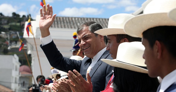 Rafael Correa waves from the presidential palace in Quito, Dec. 28, 2015.