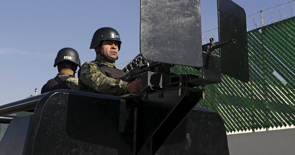 Mexican soldiers stand guard awaiting the arrival of recaptured drug lord Joaquin 