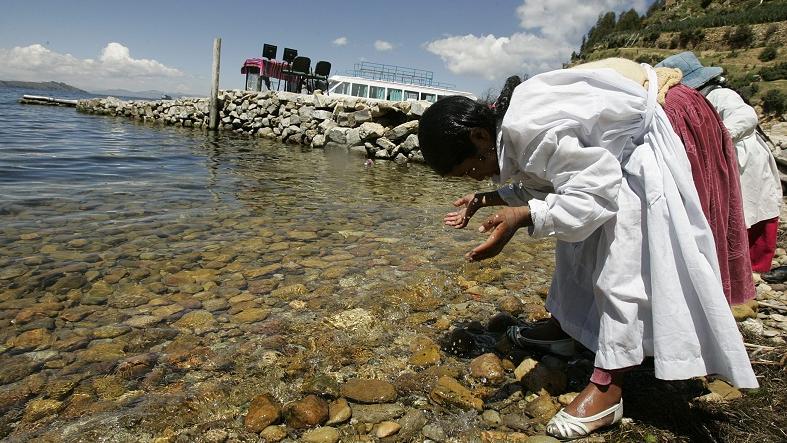 Two young Bolivians wash their faces at the edge of Lake Titicaca, Bolivia, March 4, 2009.