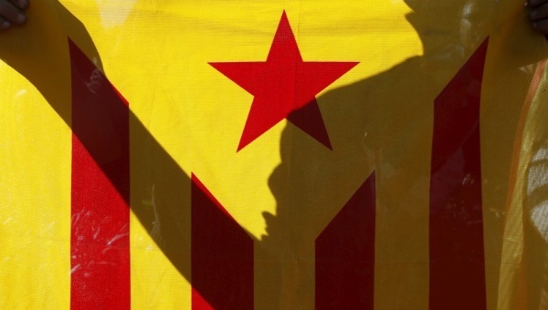 A Catalan independence supporter holds an Estelada (Catalan separatist flag) during a demonstration calling for the unity of pro-independence parties.