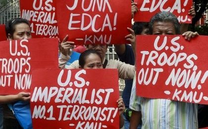 Activists hold placards denouncing the Enhanced Defense Cooperation Agreement (EDCA) during a protest outside the Supreme Court in Manila January 12, 2016.