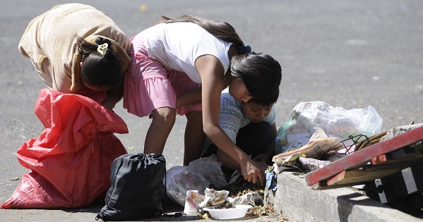 Children look for scraps outside a market in Guatemala City.