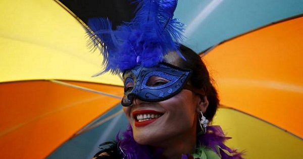 A reveler carrying an umbrella takes part in a LGBT pride parade to mark Gaijatra Festival in Nepal, August 30, 2015.