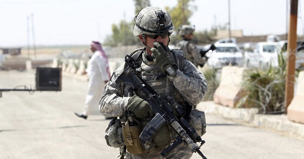 A U.S. soldier performs a radio check during a patrol in Iraq.