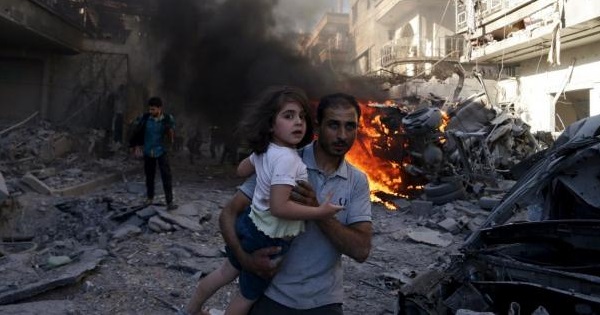 A man carries a young girl after a government airstrike on Douma, a suburb of Damascus.