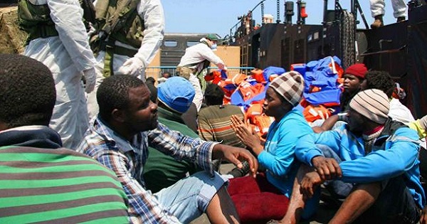 Migrants are rescued by crew from a British navy ship June 7, 2015.