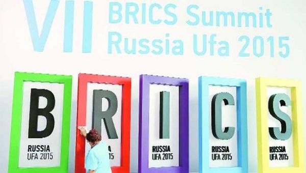 An employee cleans a board during the preparations for the BRICS summit in Ufa, Russia.