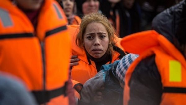 A distraught woman is rescued by the coast guard in the Aegean Sea, near Turkey's western coast.