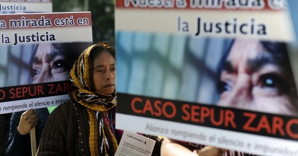 Women carry signs that read ‘We look to justice, Sepur Zarco case’ in a demonstration against violence against women in Guatemala City in 2012.
