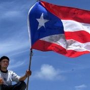 A Puerto Rican man holds up his nation's flag during a May Day event in Vieques, Puerto Rico, May 1, 2003.