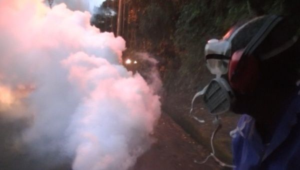 Environmental health officials in Saint Lucia fumigate neighborhoods to destroy mosquitos.