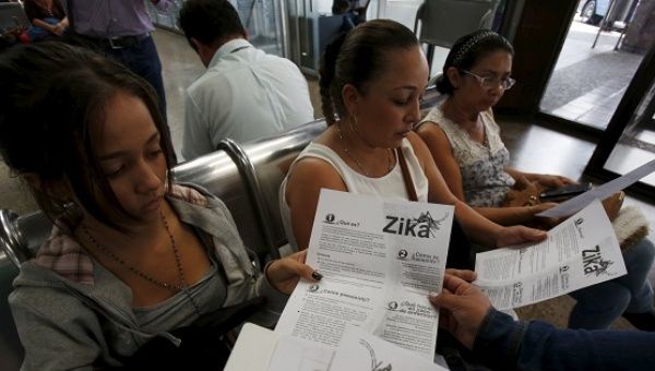 Colombian women listen as a health worker distributes information how to prevent the spread of the Zika virus, at the transport terminal in Bogota, Colombia January 31, 2016.