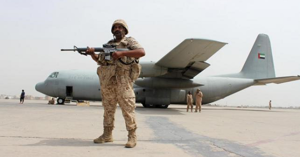 A soldier from the United Arab Emirates stands guard next to a UAE military plane at the airport of Yemen's southern port city of Aden, Aug. 8, 2015.