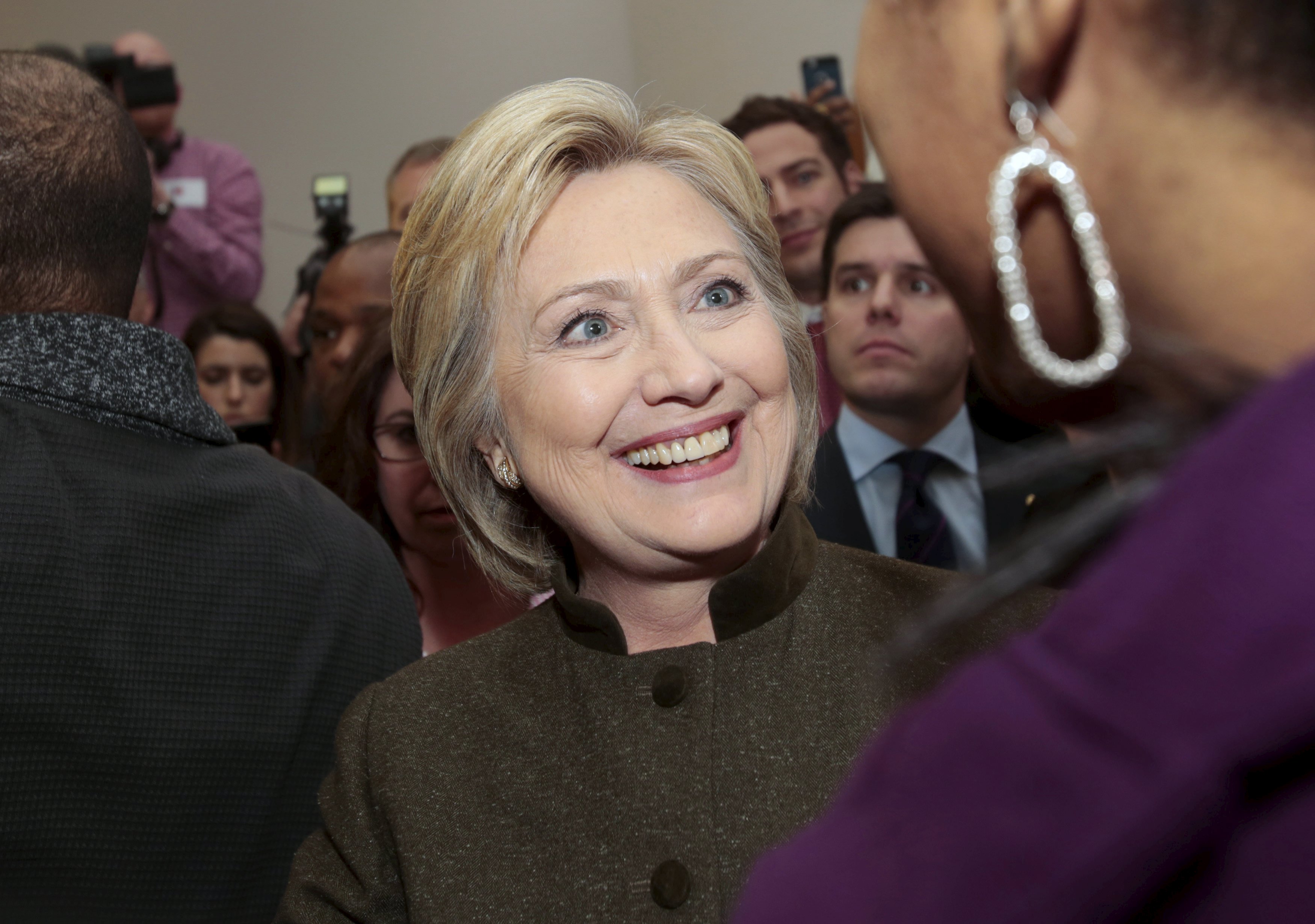 Hillary Clinton talks with a parishioner after addressing the congregation about the Flint water crisis at a Baptist church in Flint, Michigan Feb. 7, 2016