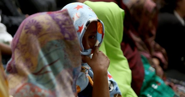 Women victims of the Sepur Zarco case cover their faces.