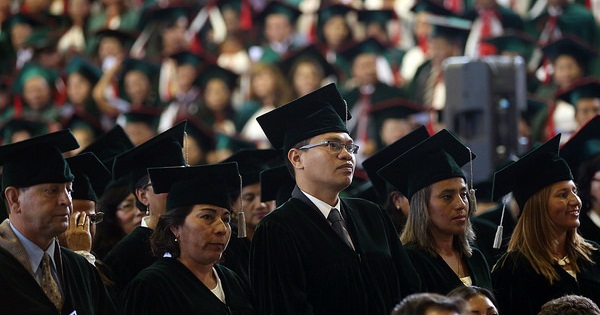 Teachers look on as they listen to speeches during their graduation ceremony where they received their master's degrees in Quito, Ecuador, Feb. 12, 2016.