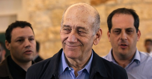 Ehud Olmert leaves Israel's Supreme Court in December 2015 after the court upheld one bribery conviction but acquitted him of another.