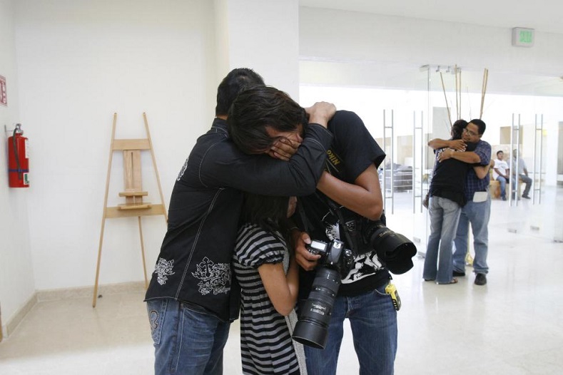 Friends, colleagues and family members embrace while mourning the death of Luis Carlos Santiago during his funeral in Ciudad Juarez September 18, 2010. Santiago, a 21-year-old news photographer working with Juarez-based newspaper El Diario, was killed after an attack by gunmen. 