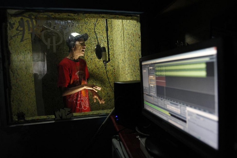 Rapper Pok 27 performs live in a home studio in Ciudad Juarez April 18, 2011. Young Mexican rappers are using Internet radio to vent their anger at the shocking killings sparked by the drug war, winning fans in cities from Los Angeles to Buenos Aires but also facing death threats from gunmen.