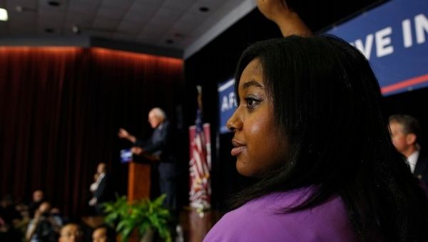 Erica Garner, daughter of Eric Garner, raises her hand to ask Sanders a question at a campaign event in Columbia, S.C., Feb. 16, 2016. 
