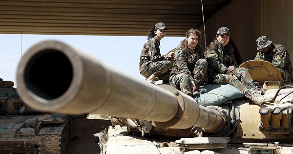 Members of a female commando battalion in the Syrian Army sit atop a tank in the government-controlled area of Jobar, a suburb of Damascus.