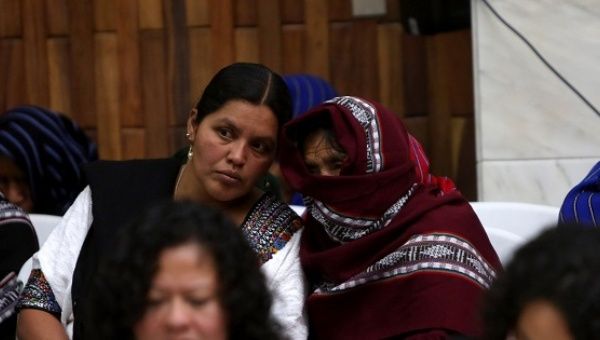 A witness in the Sepur Zarco trial hides her face with a headscarf. 