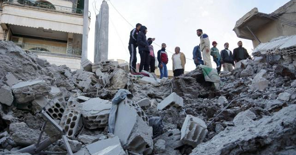Residents inspect a damaged site from what activists said were airstrikes carried out by the Russian air force in Nawa city, Deraa, Syria, Nov. 21, 2015.