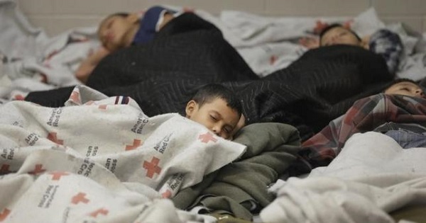 Migrant detainees sleep in a holding cell at a U.S. Customs and Border Protection processing facility, in Brownsville, Texas June 18, 2014.