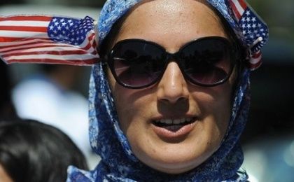 A woman adorns her hijab with U.S. flags.