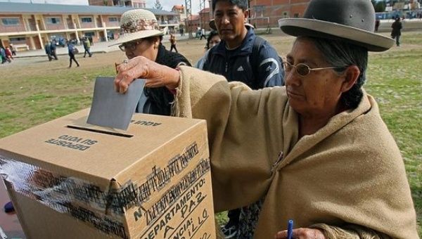 A voter casts her ballot in Bolivia's national referendum Feb. 21, 2016.