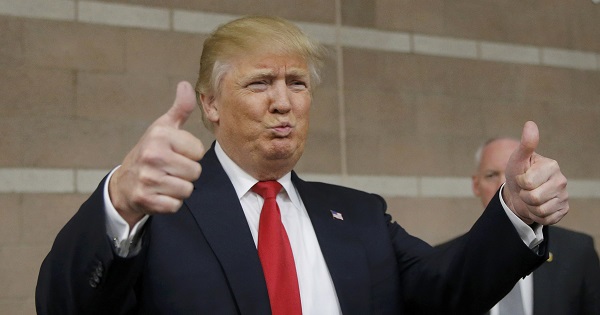 Republican U.S. presidential candidate Donald Trump gives thumbs up to caucus goers as he visits a Nevada Republican caucus site at Palo Verde High School in Las Vegas, Nevada February 23, 2016.