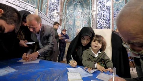 Iranians fill ballots during elections for Assembly of Experts, which has the power to appoint and dismiss the supreme leader, in Tehran Feb. 26, 2016.