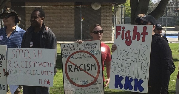 Counter protesters hold placards near a planned Klu Klux Klan rally in Anaheim, California.