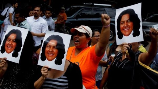 Protesters demonstrate with photos of murdered Indigenous leader Berta Caceres in Tegucigalpa, Honduras, March 3, 2016.
