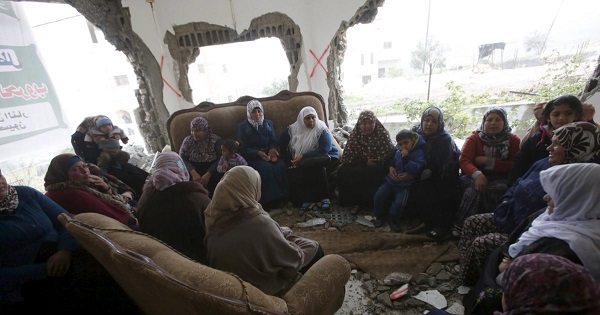 Palestinians gather in the home of Mohammed al-Haroub after it was partially demolished by Israeli army in the West Bank village of Dir Samt, south of Hebron Feb. 23, 2016.