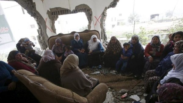 Palestinians gather in the home of Mohammed al-Haroub after it was partially demolished by Israeli army in the West Bank village of Dir Samt, south of Hebron Feb. 23, 2016. 