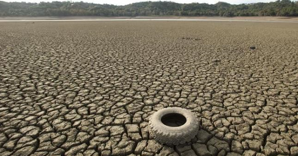 A tire rests on the dry bed of Lake Mendocino, a key Mendocino County reservoir, in Ukiah, California Feb. 25, 2014.