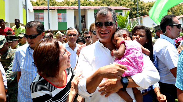 Ecuadorean President Correa greets a child as he tours a new social housing complex in the province of Esmeraldas, Ecuador, March 9, 2016.