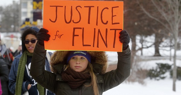 Demonstrators protest over the Flint, Michigan, contaminated water crisis outside of the venue where the Democratic U.S. presidential candidates' debate was being held in Flint, Michigan.