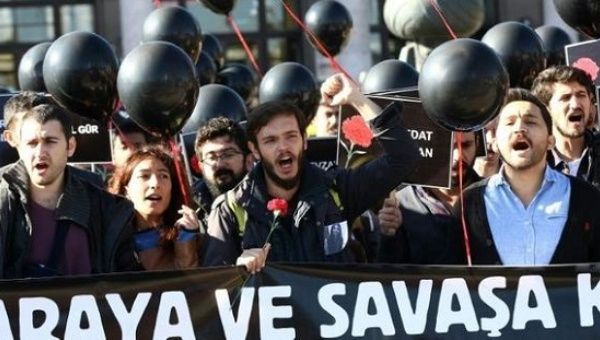 People hold a banner in tribute of the victims of last year's bombings in Ankara on March 10, 2016.