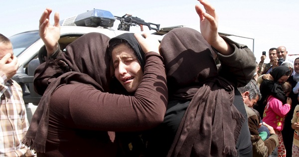 Women members of the Yazidi sect react after being released by the Islamic State group in Iraq.