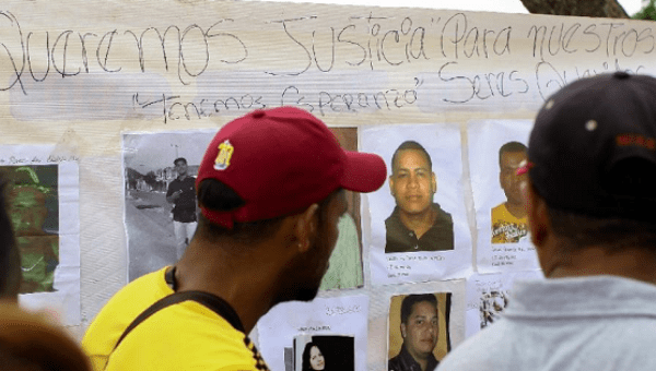 Relatives and friends of the 28 miners who went missing in the town of Tumeremo, Venezuela, demand answers from officials, March 8, 2016.