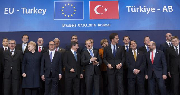 Turkish Prime Minister Ahmet Davutoglu (C) poses with European Union leaders during a EU-Turkey summit in Brussels, March 7, 2016.