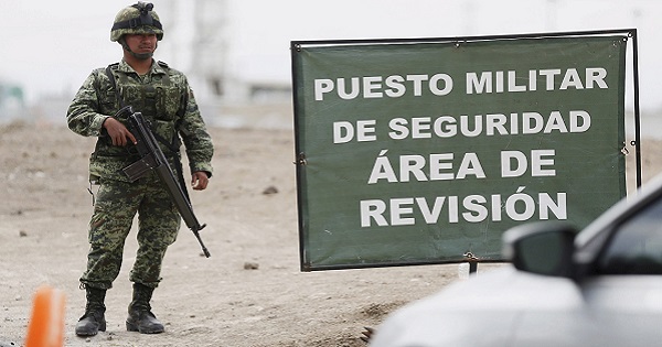 A soldier stands guard at a checkpoint on the perimeter of the Altiplano Federal Penitentiary where drug lord Joaquin 