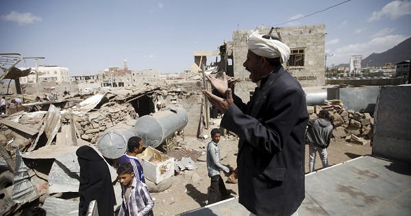 A man shouts for help to salvage his furniture after his house was destroyed by a Saudi-led air strike in Yemen's capital Sanaa, Feb. 25, 2016.