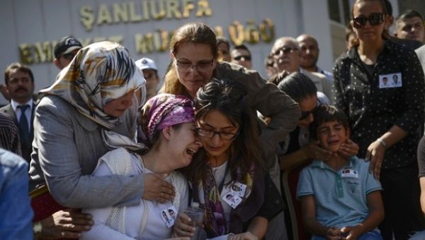 Relatives of one of two Turkish police officers killed in clashes with Kurdistan Workers' Party (PKK) militants, mourn during their funeral procession on 23 July 2015, in Sanliurfa.